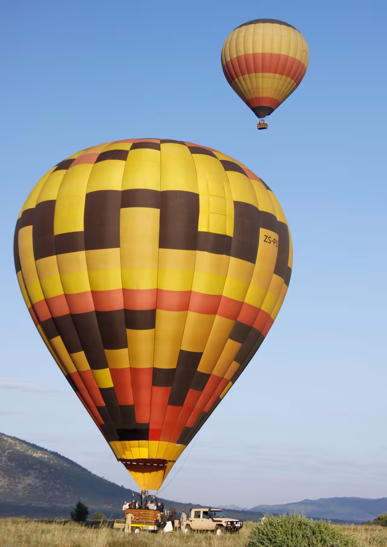Hot air balloon floating over the Masai Mara at dawn